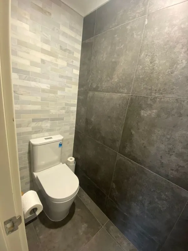 Small modern toilet with grey tiled walls in a Perth bathroom renovation