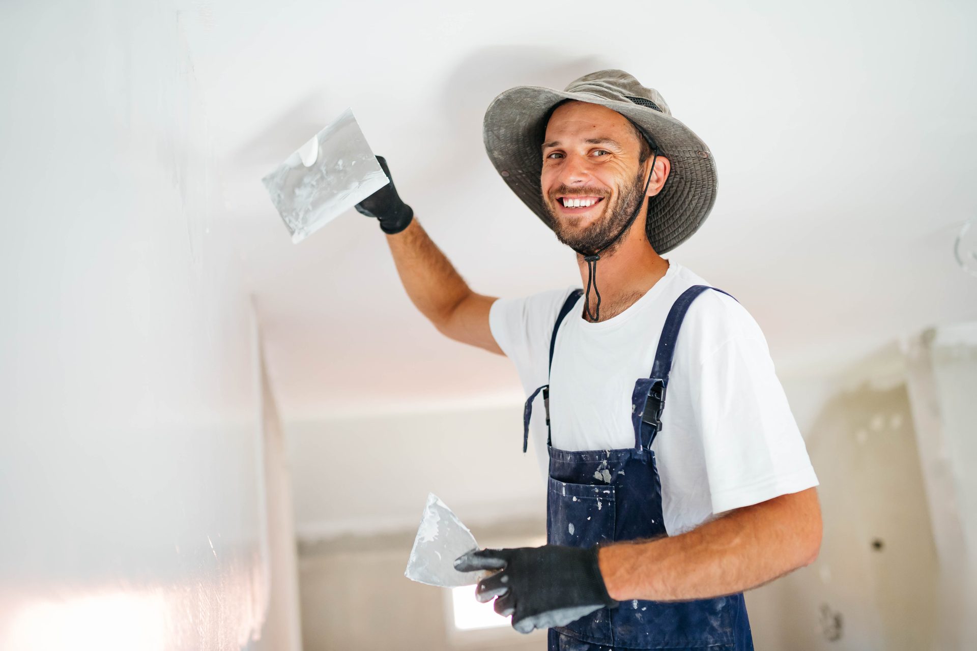Professional painter preparing interior walls in a Perth home