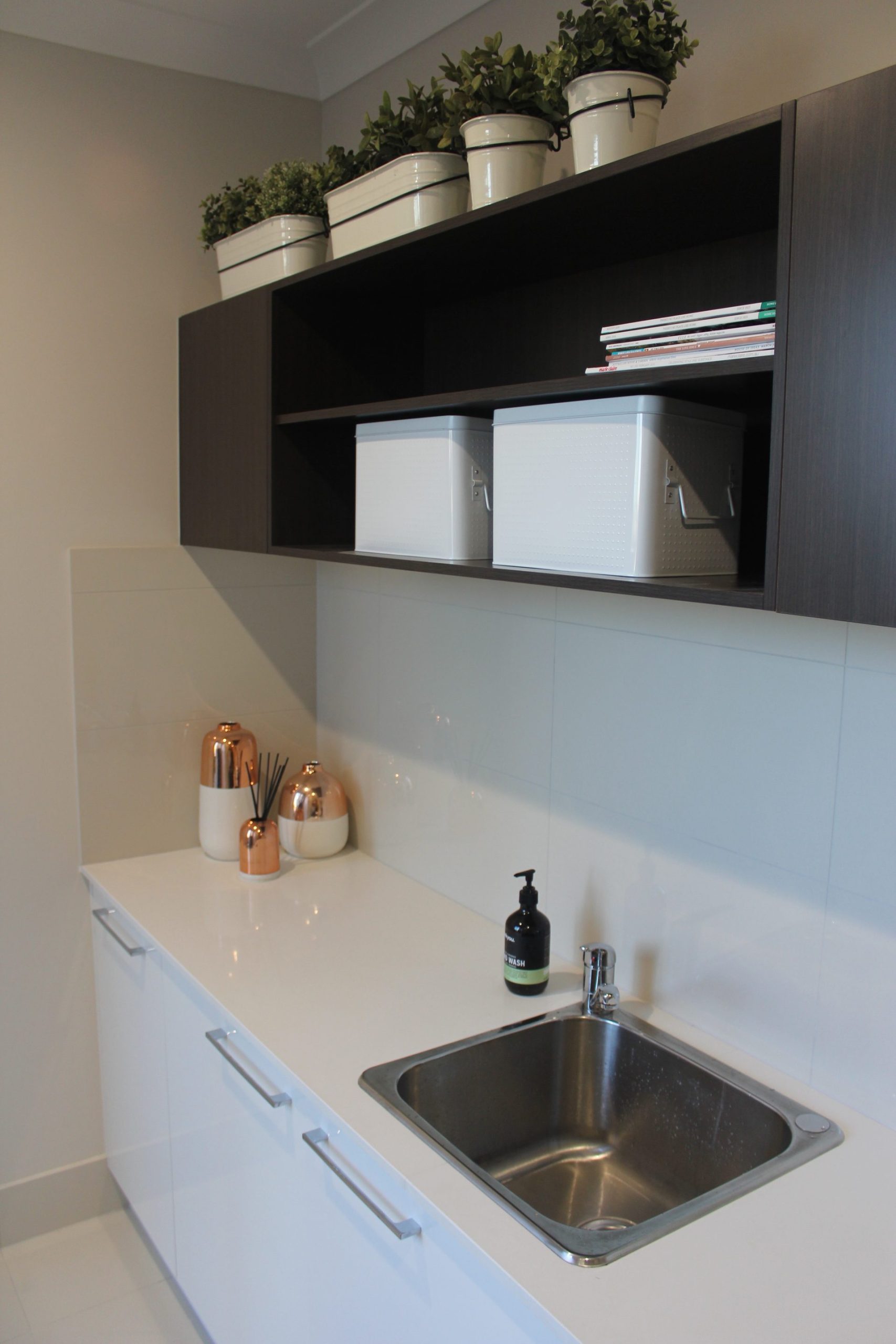 Modern L-shape laundry with extensive storage and bench space