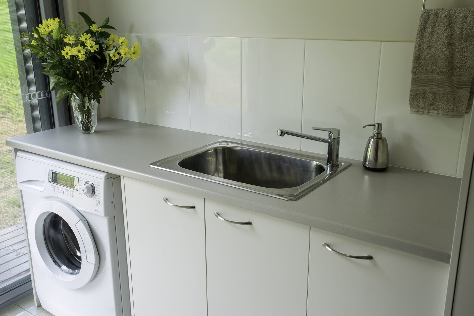Modern laundry with sink and washing machine