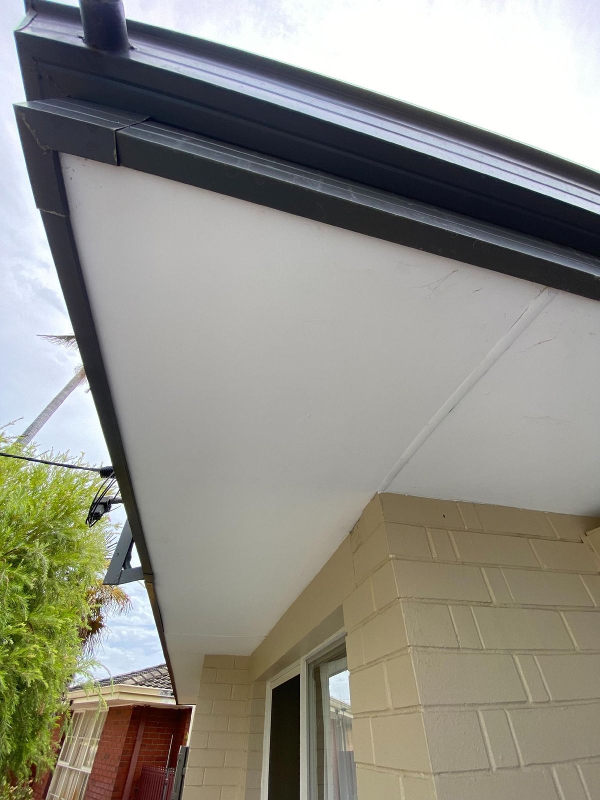 Close up of clean house eaves and functional Colorbond guttering